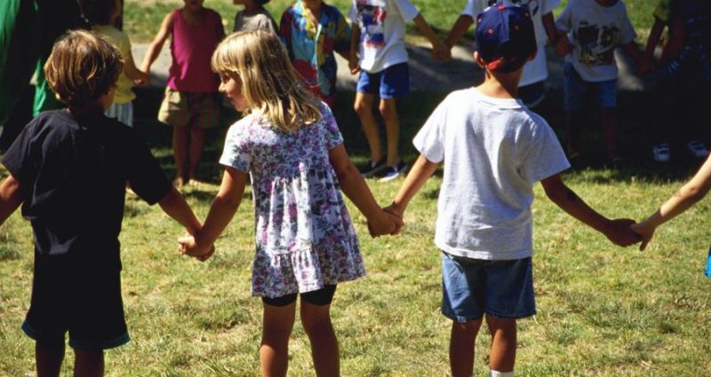 Children Holding Hands on School Playground
